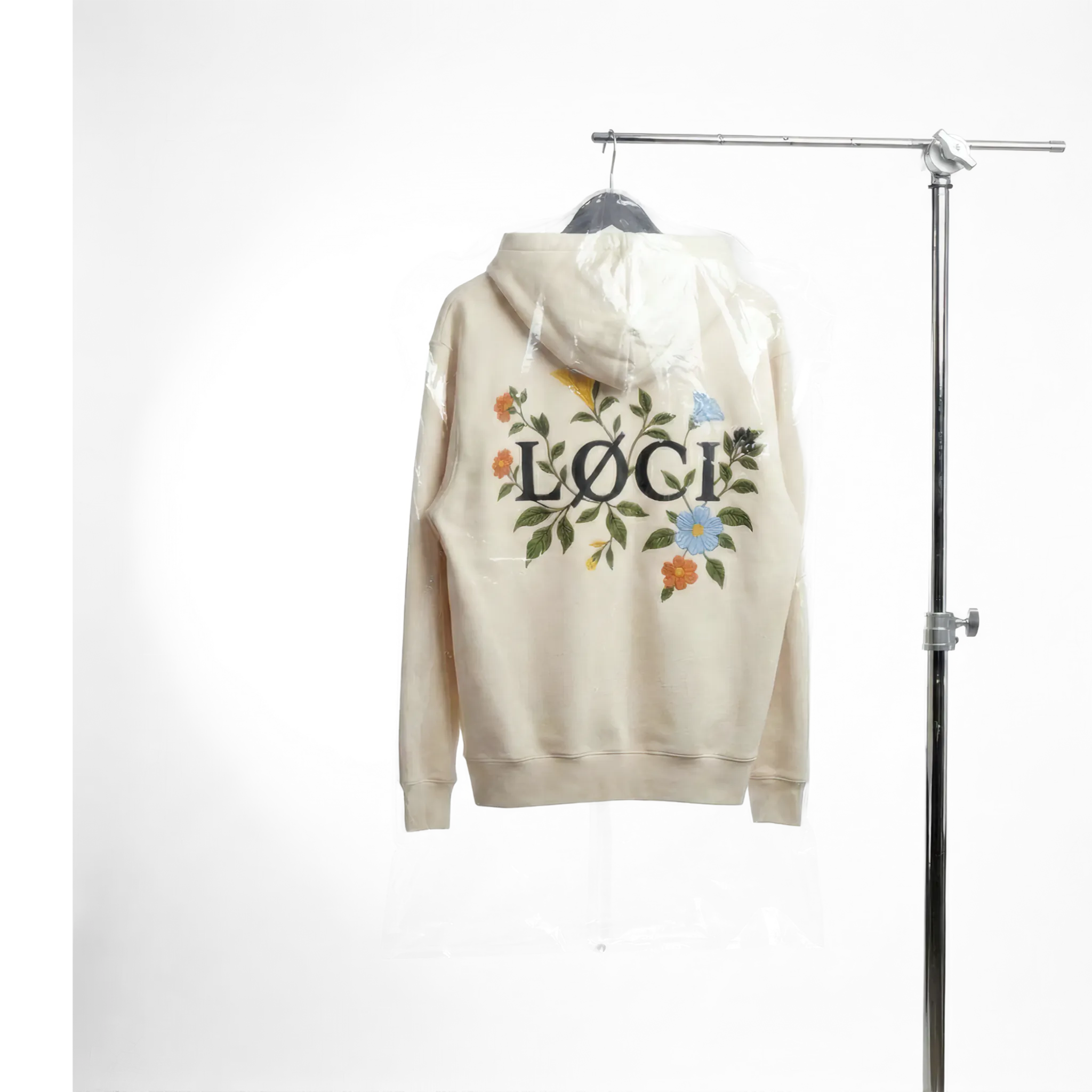 Beige hoodie with floral design and 'LOVE' text on a hanger against a white background