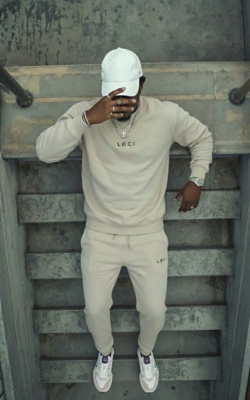 LØCI cream matching sweatshirt and trousers worn on a stairway