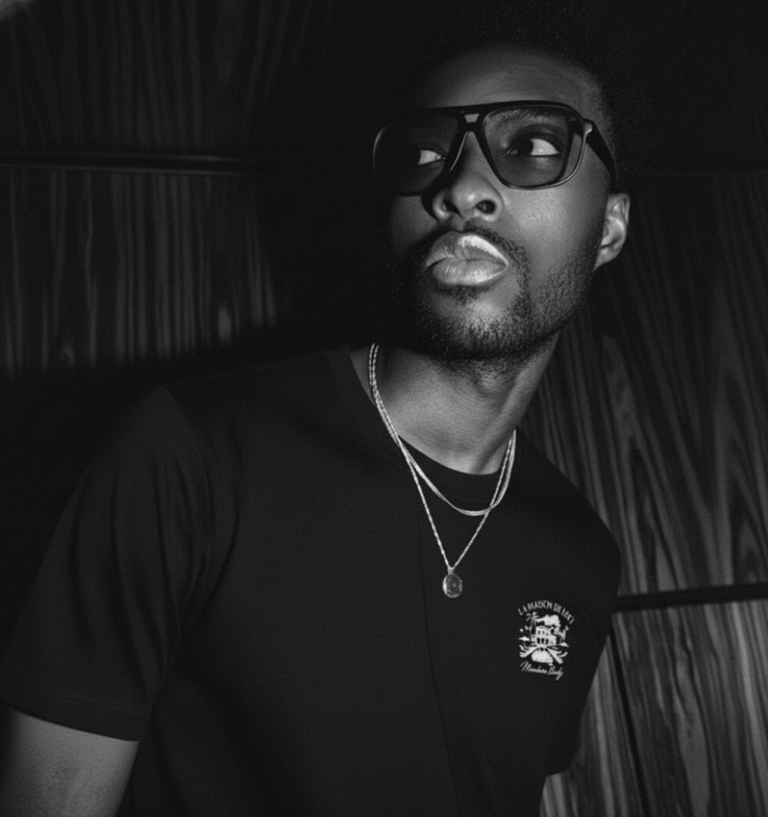 Male model wearing a black LØCI La Maison tee